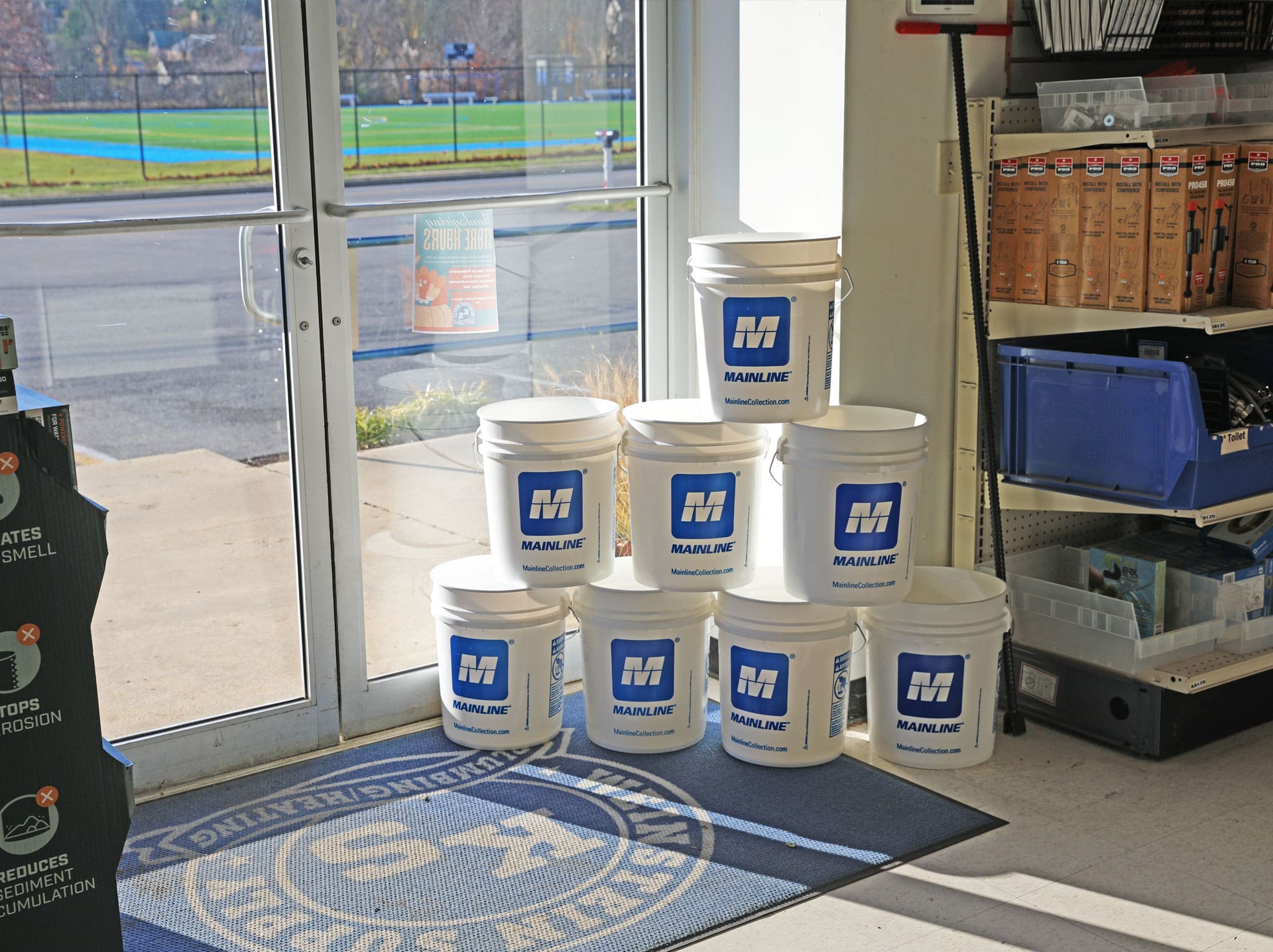 Weinstein Plumbing Supply Kennett Square PA Mainline branded buckets stacked by entrance