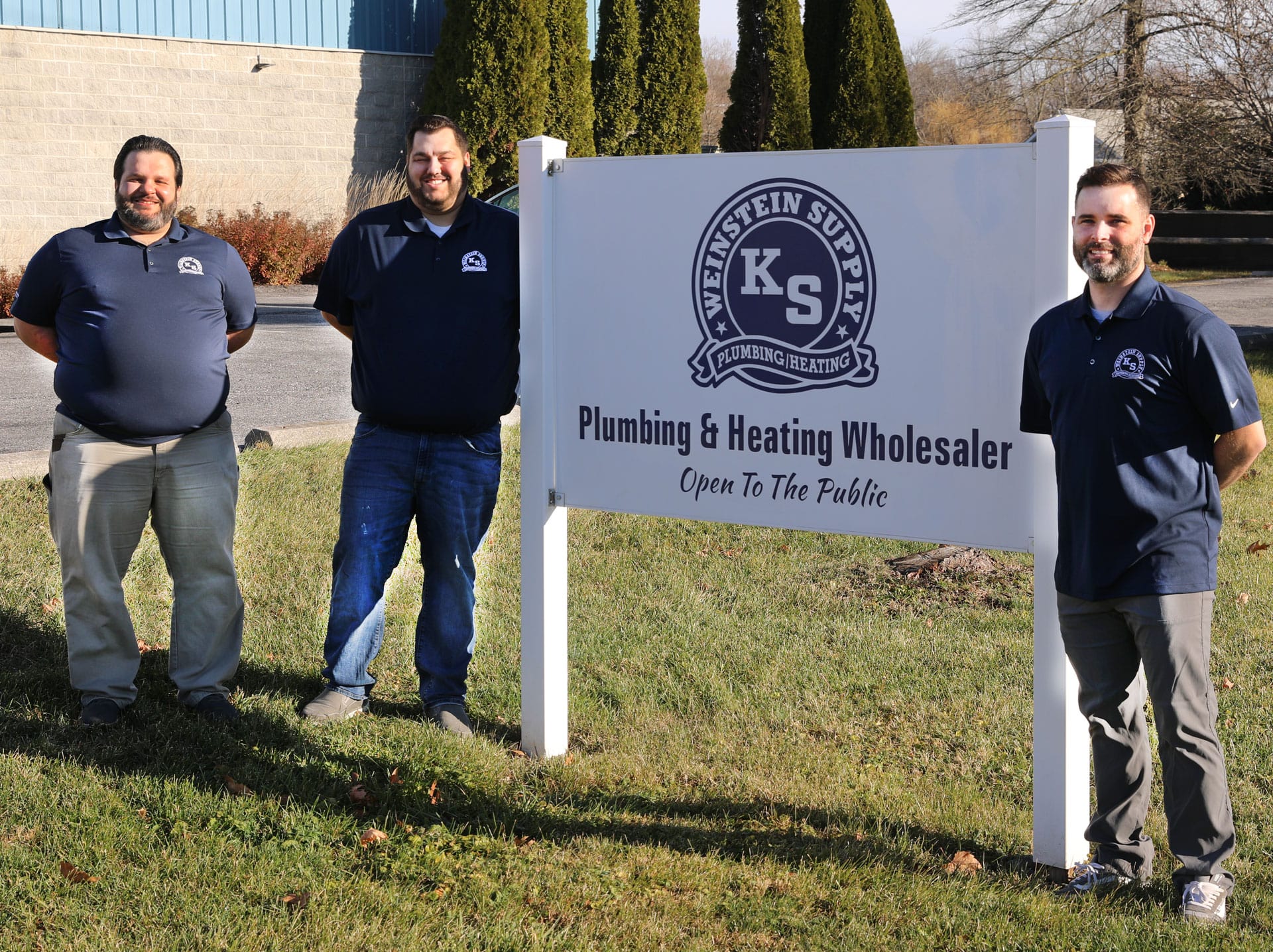 Weinstein Plumbing Supply Kennett Square PA team members standing by sign in from of location